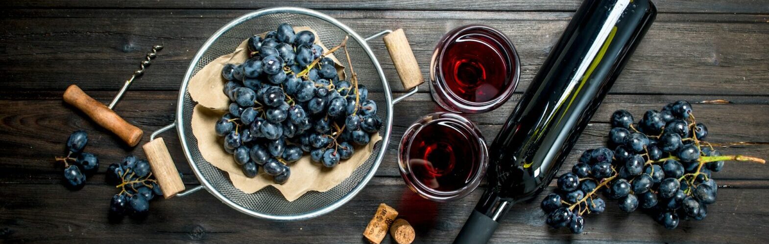 Wine background. Red wine in glasses with grapes.